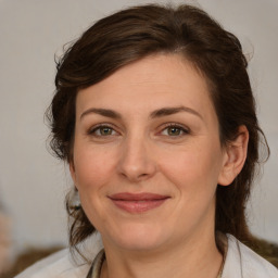 Joyful white adult female with medium  brown hair and brown eyes