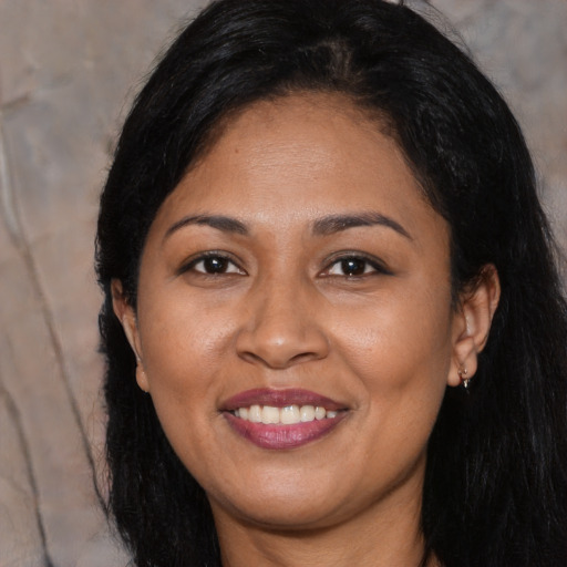Joyful latino young-adult female with long  black hair and brown eyes