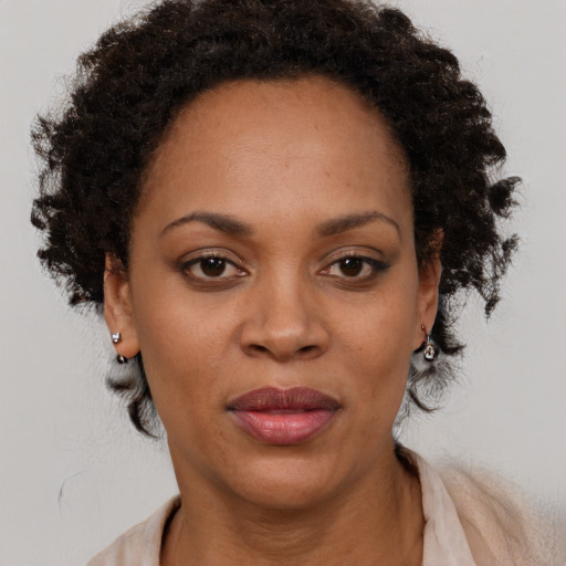 Joyful black adult female with short  brown hair and brown eyes