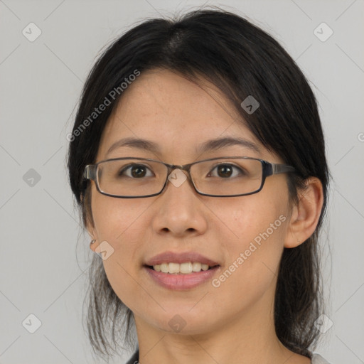 Joyful asian adult female with medium  brown hair and brown eyes