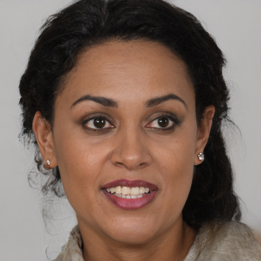 Joyful black adult female with medium  brown hair and brown eyes