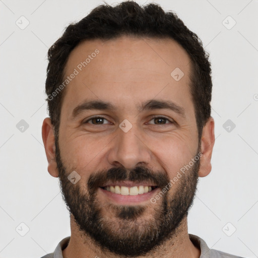 Joyful white young-adult male with short  black hair and brown eyes