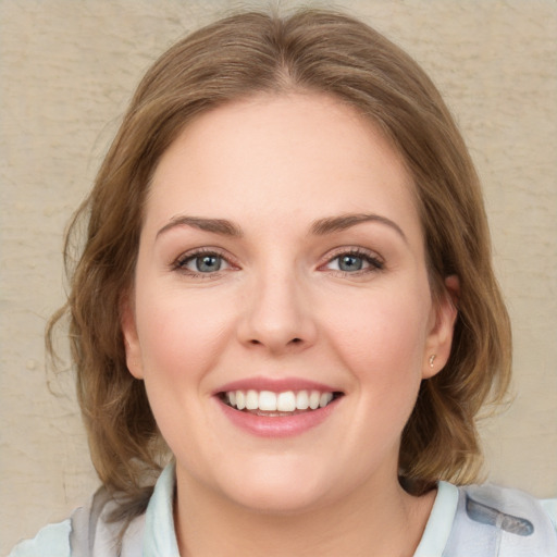 Joyful white young-adult female with medium  brown hair and blue eyes