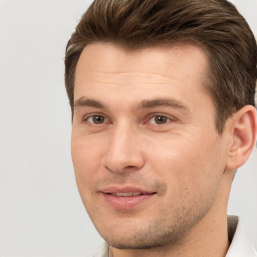 Joyful white young-adult male with short  brown hair and brown eyes