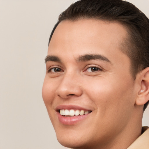 Joyful white young-adult male with short  brown hair and brown eyes