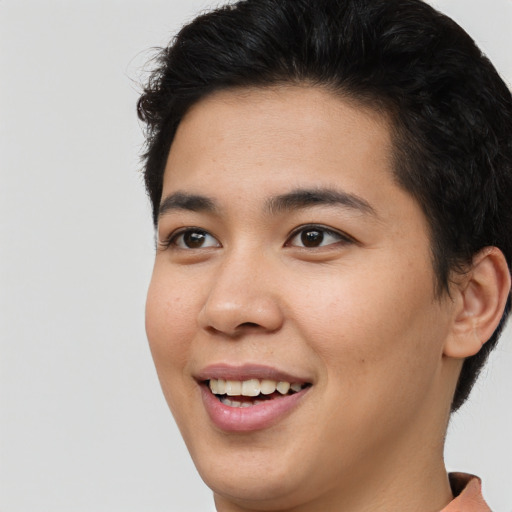 Joyful latino young-adult male with short  brown hair and brown eyes