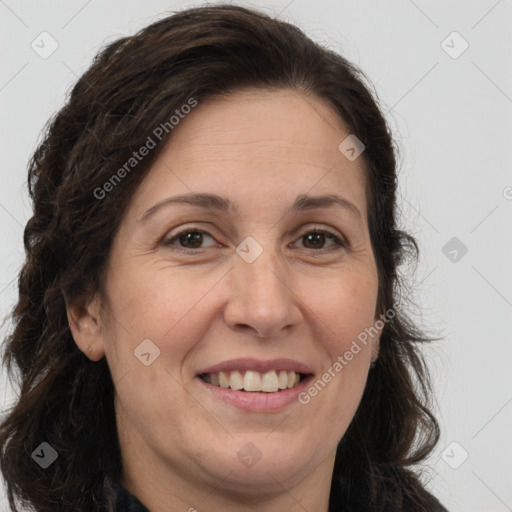 Joyful white adult female with long  brown hair and brown eyes