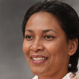 Joyful black adult female with medium  brown hair and brown eyes