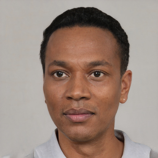 Neutral black adult male with short  black hair and brown eyes