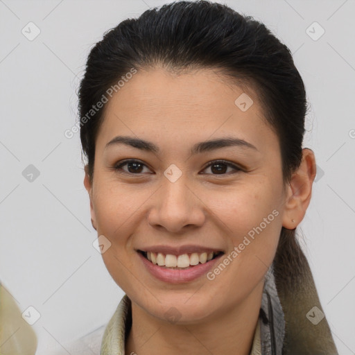 Joyful latino young-adult female with medium  brown hair and brown eyes