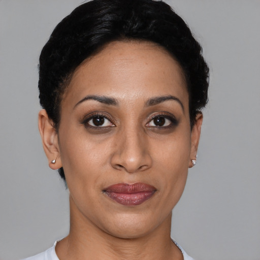 Joyful latino young-adult female with short  black hair and brown eyes