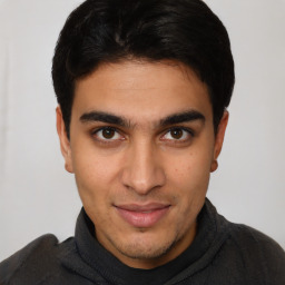 Joyful latino young-adult male with short  brown hair and brown eyes