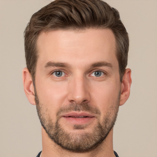 Joyful white young-adult male with short  brown hair and grey eyes