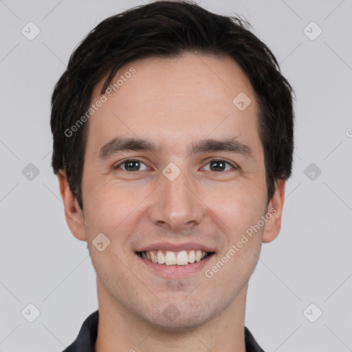 Joyful white young-adult male with short  black hair and brown eyes