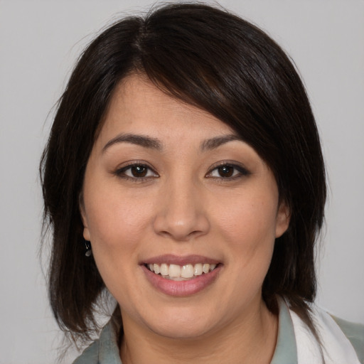 Joyful asian young-adult female with medium  brown hair and brown eyes