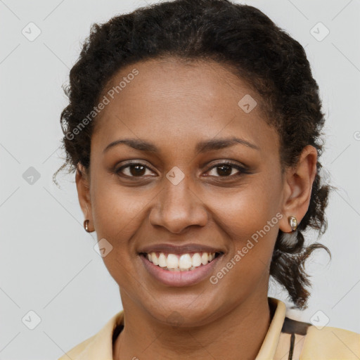 Joyful black young-adult female with short  brown hair and brown eyes