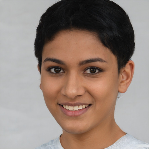 Joyful latino young-adult female with short  black hair and brown eyes