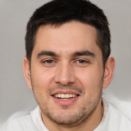 Joyful white adult male with short  brown hair and brown eyes