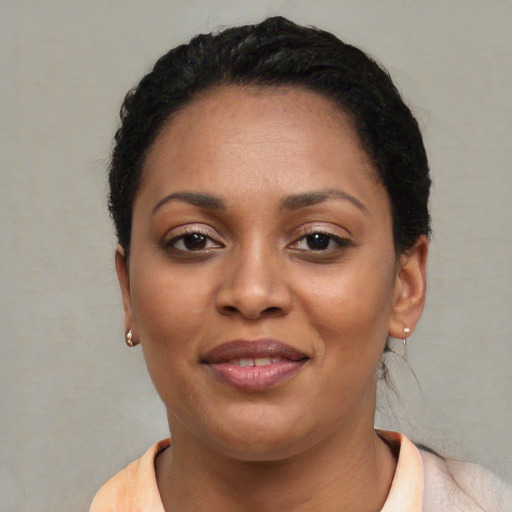 Joyful latino young-adult female with short  black hair and brown eyes