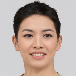 Joyful asian young-adult female with short  black hair and brown eyes