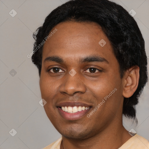 Joyful black young-adult male with short  black hair and brown eyes