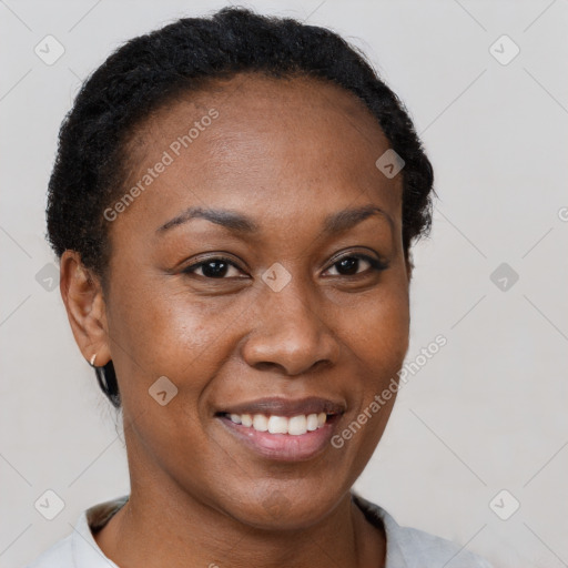 Joyful black adult female with short  brown hair and brown eyes