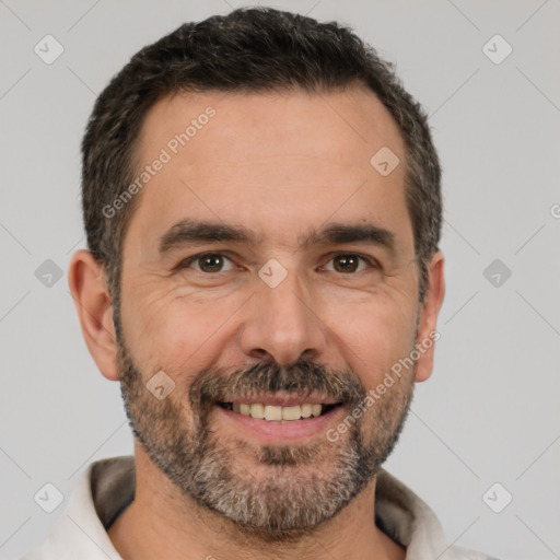 Joyful white adult male with short  black hair and brown eyes