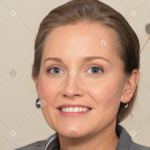 Joyful white adult female with medium  brown hair and grey eyes