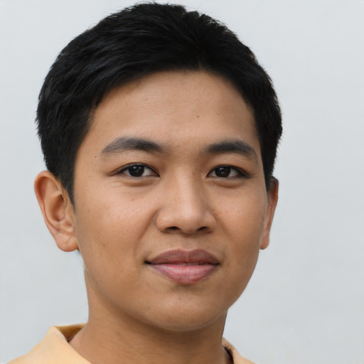 Joyful asian young-adult male with short  black hair and brown eyes