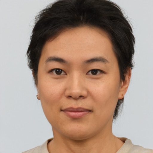 Joyful asian young-adult female with short  brown hair and brown eyes