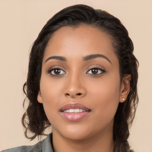 Joyful latino young-adult female with long  black hair and brown eyes