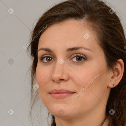 Joyful white adult female with long  brown hair and brown eyes