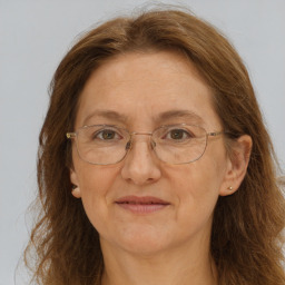 Joyful white adult female with long  brown hair and brown eyes