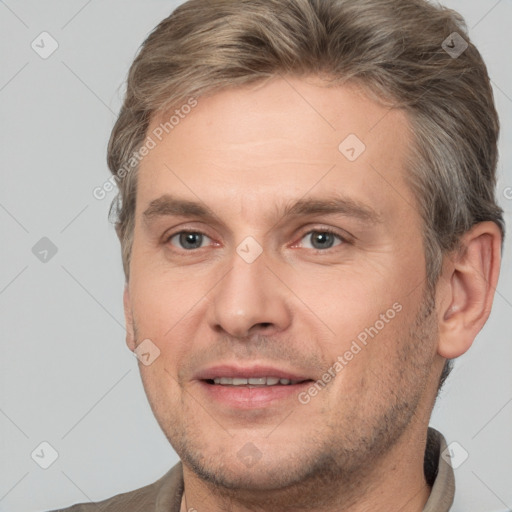 Joyful white adult male with short  brown hair and brown eyes