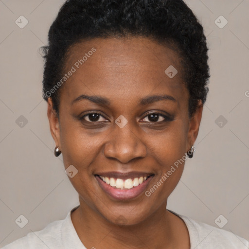 Joyful black young-adult female with short  black hair and brown eyes