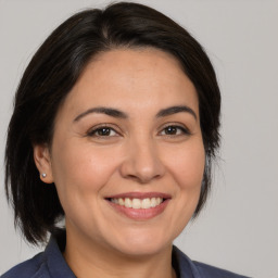 Joyful white adult female with medium  brown hair and brown eyes