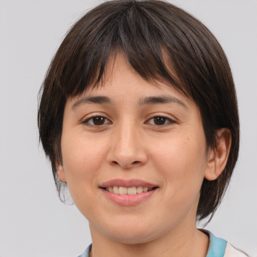 Joyful white young-adult female with medium  brown hair and brown eyes