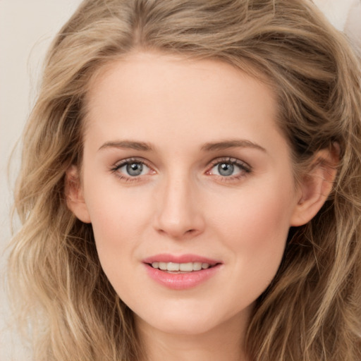 Joyful white young-adult female with long  brown hair and green eyes