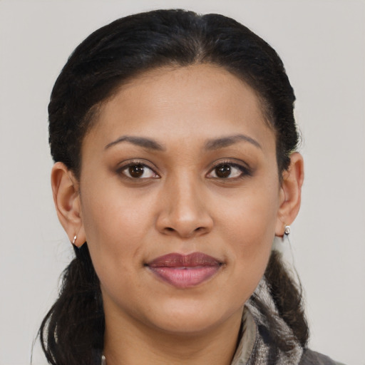 Joyful latino young-adult female with medium  brown hair and brown eyes