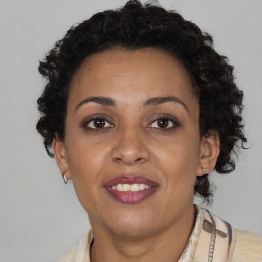 Joyful black adult female with short  brown hair and brown eyes