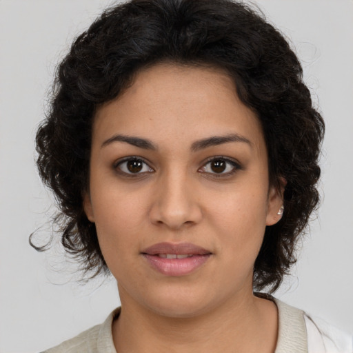 Joyful latino young-adult female with medium  brown hair and brown eyes