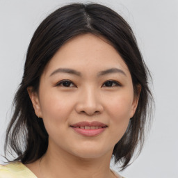 Joyful asian young-adult female with medium  brown hair and brown eyes