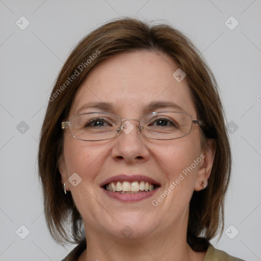 Joyful white adult female with medium  brown hair and blue eyes