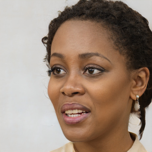 Joyful black young-adult female with short  brown hair and brown eyes