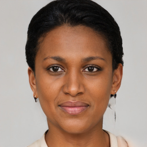 Joyful latino young-adult female with short  black hair and brown eyes