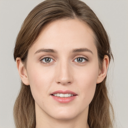 Joyful white young-adult female with long  brown hair and grey eyes