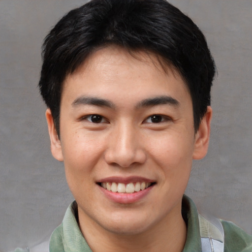 Joyful asian young-adult male with short  brown hair and brown eyes