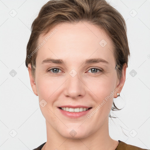 Joyful white young-adult female with short  brown hair and grey eyes