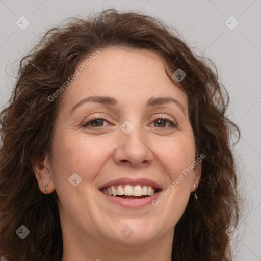 Joyful white adult female with long  brown hair and brown eyes