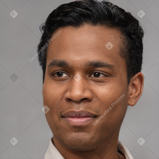 Joyful black young-adult male with short  black hair and brown eyes